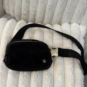 lululemon black fuzzy belt bag with gold zipper